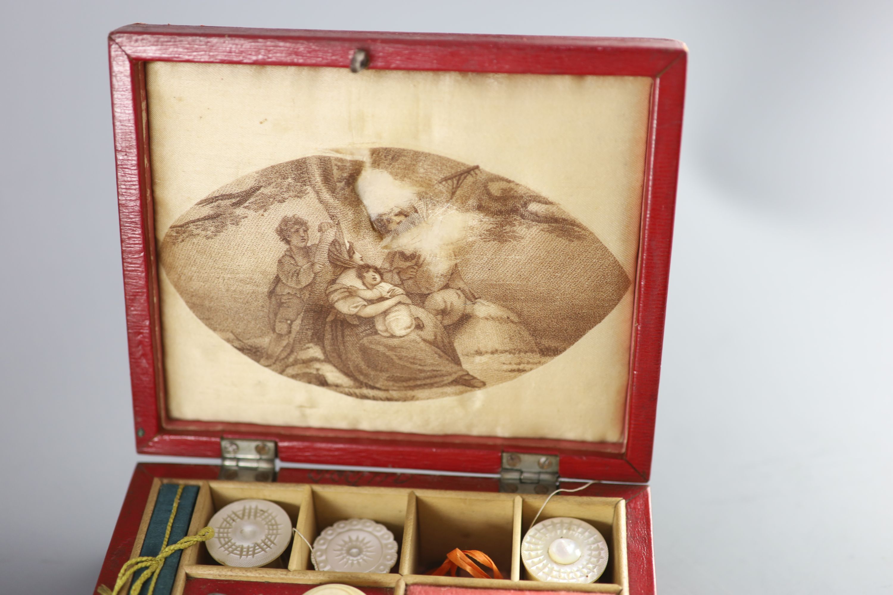 Two early 19th century red leather work boxes with assorted fittings